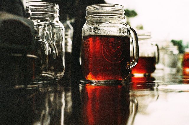 Once the tea has cooled down, combine it with the kombucha in the glass mason jar. 