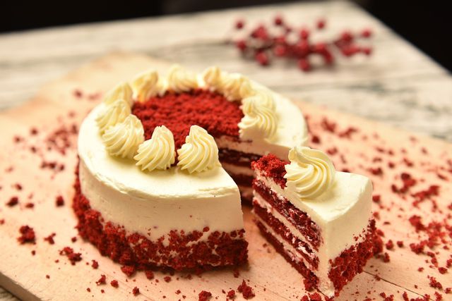 Red velvet cake is layered with vegan cream cheese frosting.