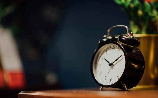 Setting an alarm can help get your body clock back on track. 