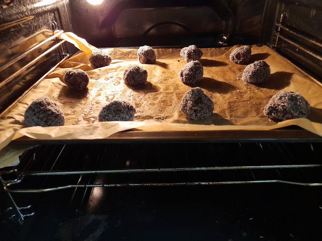 Chocolate snowball cookies baking in oven.