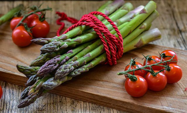 Green asparagus and red cherry tomatoes look and taste wonderful in a vegan quiche
