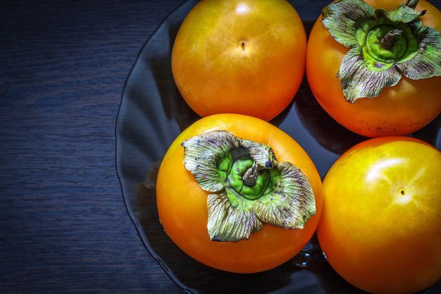 Ripe persimmons will be bright orange and firm to the touch.
